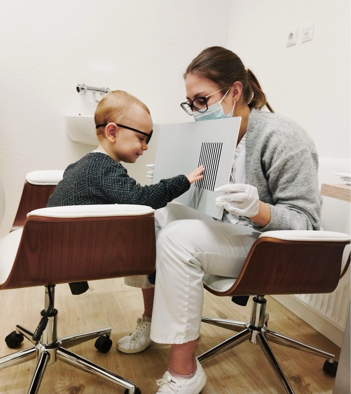 Child participating in a TAC (Tactile Acuity Chart) test